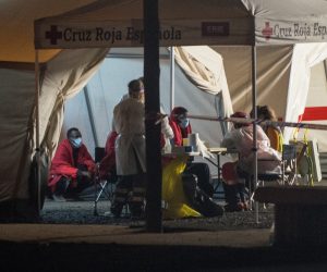 epa08651927 Red Cross and Rescue Navy members help some of the 50 Subsaharian migrants who travelled in a small boat which have been rescued 65 kilometes far away and brought to the Arrecife dock in Tenerife, Canary Islands, Spain on 07 September 2020.  EPA/Javier Fuentes Figueroa