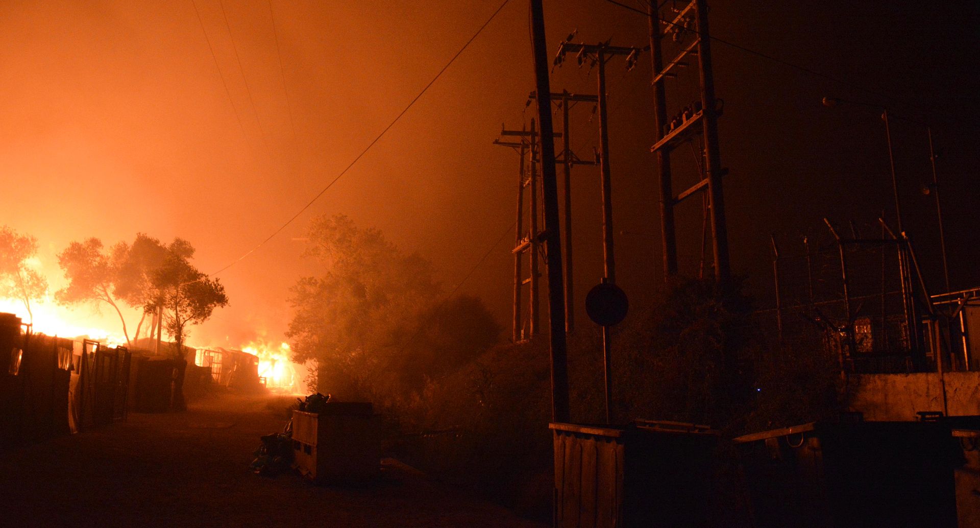 epa08655818 Flames burn in the Moria refugees camp on the island of Lesbos, Greece, 09 September 2020. According to reports, afire broke out at Moria Camp early on 09 September, after approximatley 35 refugees, who had tested positive for COVID-19, refused to move into isolation with their families.  EPA/STRATIS BALASKAS