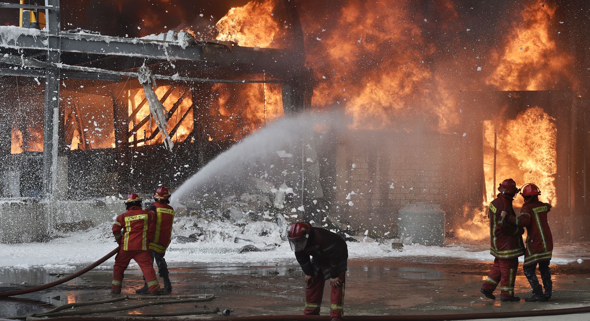 epa08658807 Lebanese firefighters try to extinguish a fire at a Port of Beirut, Lebanon, 10 September 2020. A massive fire is raging at the port of Beirut, a little more than a month after a huge explosion rocked the harbor facilities and surrounding area. The cause of the fire was not immediately kn​own.  EPA/WAEL HAMZEH