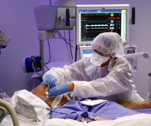 epa08659666 Doctors and nurses wearing their protective gear (blouse, gloves and mask) take care of a patient suffering from the coronavirus disease (COVID-19) at the resuscitation intensive care unit (ICU) of the Hopital Europeen hospital in Marseille, France, 10 September 2020. According to recent hospital reports, the number of Covid-19 patients in intensive care beds in the Marseille area has more than doubled in a few days, nearing full capacity. President Macron has declared that new measures will be announced on 11 September in an attempt to stop  the rise in Covid-19 infections across France.  EPA/Guillaume Horcajuelo ATTENTION EDITORS: THE IMAGES OF THE PATIENT ARE PIXELIZED FOR LEGAL REASONS CONCERNING PERSONAL RIGHTS.
