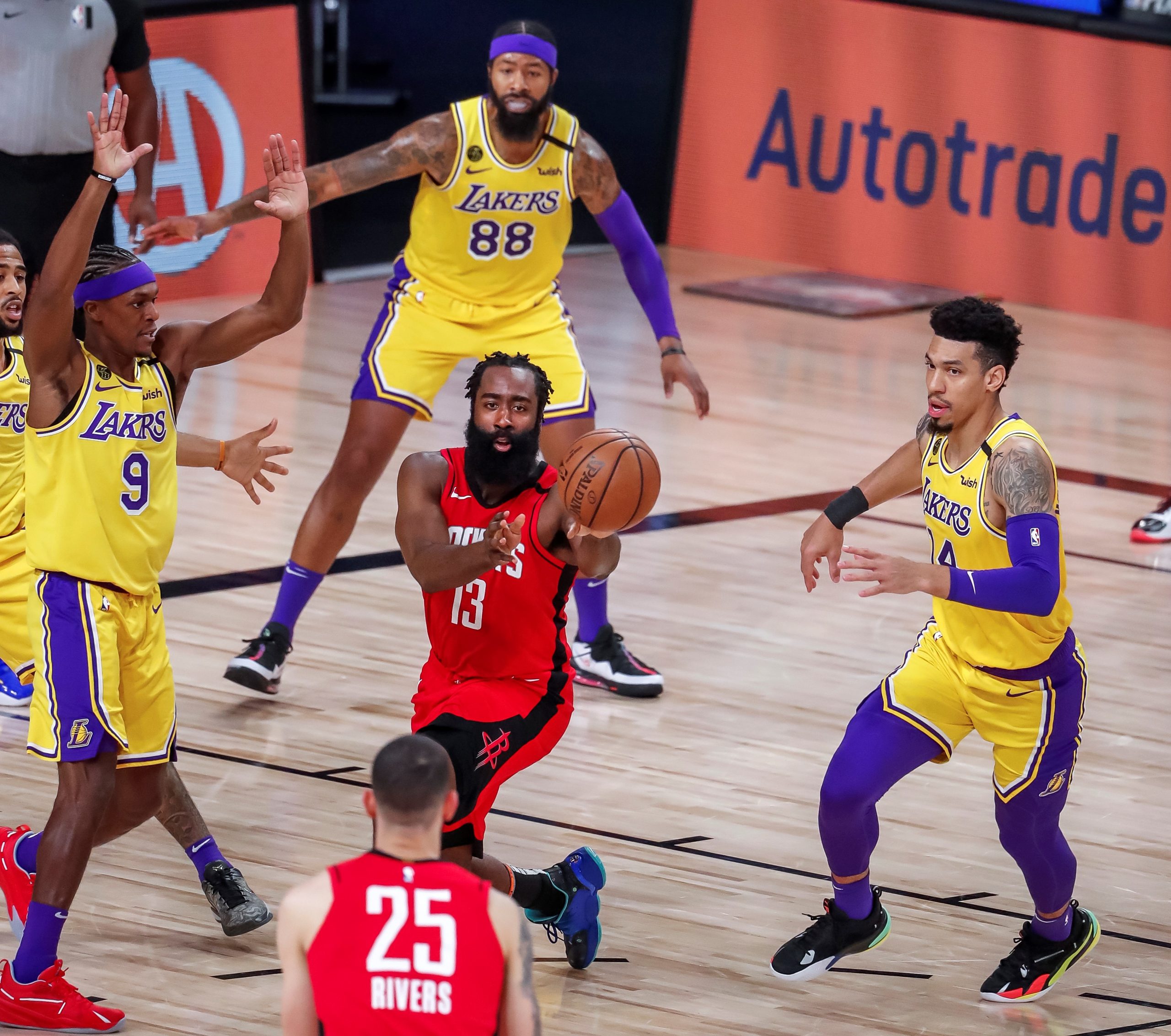 epa08660264 Houston Rockets guard James Harden (C) passes to Houston Rockets guard Austin Rivers (bottom) while guarded by Los Angeles Lakers guard Rajon Rondo (L) and Los Angeles Lakers guard Danny Green (R) during the first half of the NBA basketball semifinal Western Conference playoff game four between the Los Angeles Lakers and the Houston Rockets at the ESPN Wide World of Sports Complex in Kissimmee, Florida, USA, 10 September 2020.  EPA/ERIK S. LESSER  SHUTTERSTOCK OUT