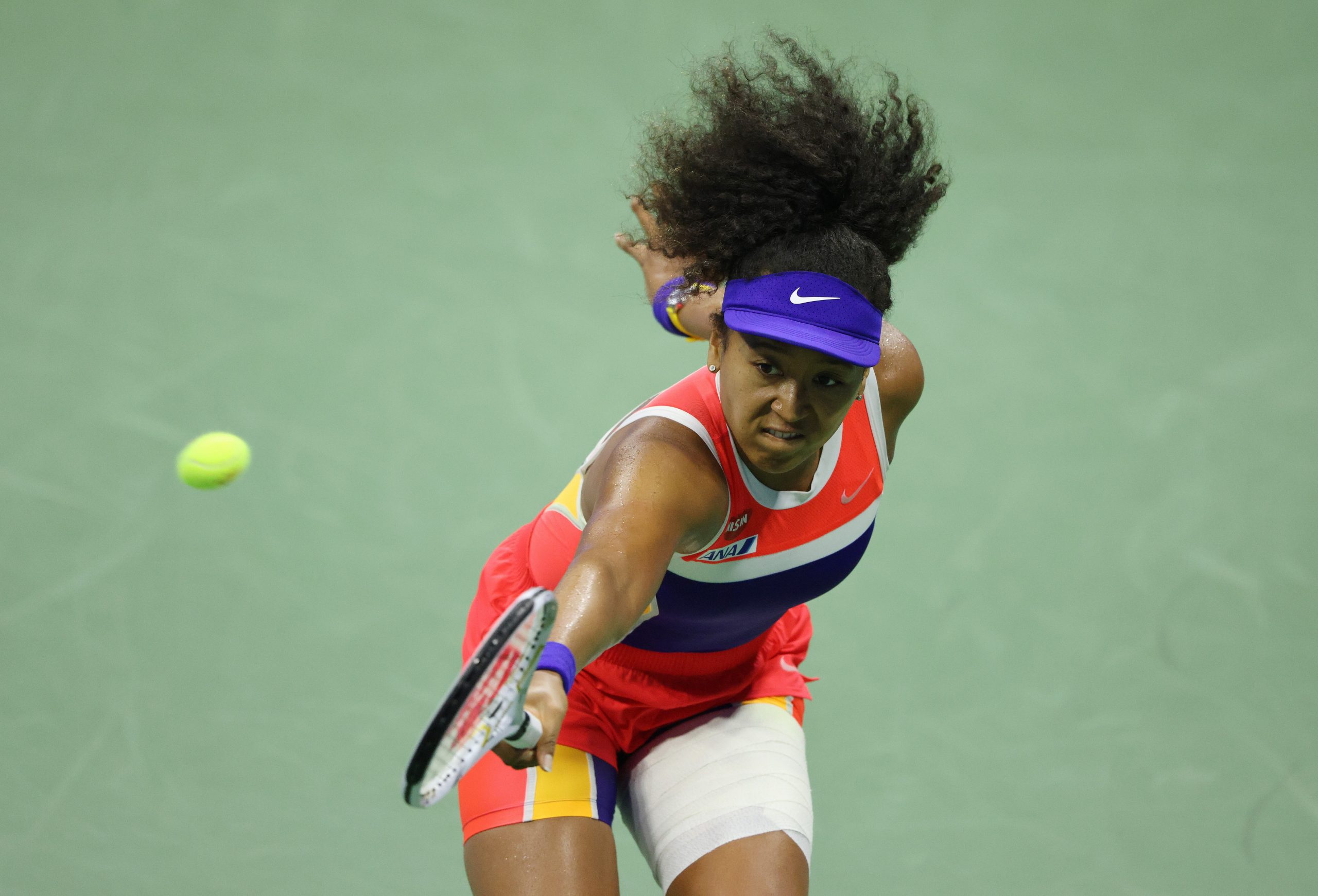 epa08660309 Naomi Osaka of Japan hits a return to Jennifer Brady of the US during their Women's Semifinal match on the eleventh day of the US Open Tennis Championships the USTA National Tennis Center in Flushing Meadows, New York, USA, 10 September 2020. Due to the coronavirus pandemic, the US Open is being played without fans and runs from 31 August through 13 September.  EPA/JUSTIN LANE