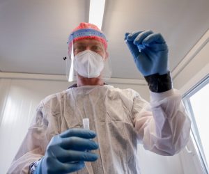 epa08667687 A nurse preparing to collect a swab sample at the Covid-19 test centre at Brussels Airport in Brussels, Belgium, 14 September 2020.  EPA/STEPHANIE LECOCQ
