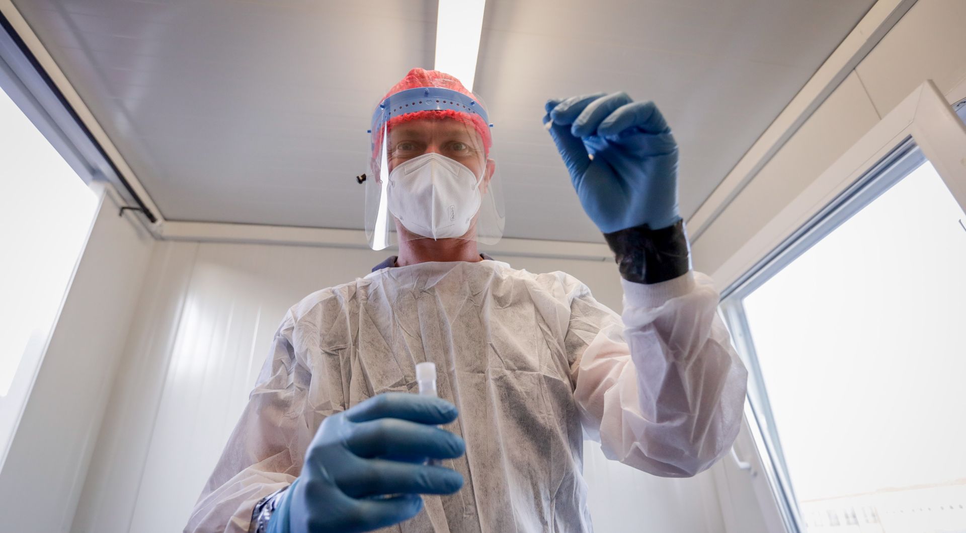 epa08667687 A nurse preparing to collect a swab sample at the Covid-19 test centre at Brussels Airport in Brussels, Belgium, 14 September 2020.  EPA/STEPHANIE LECOCQ