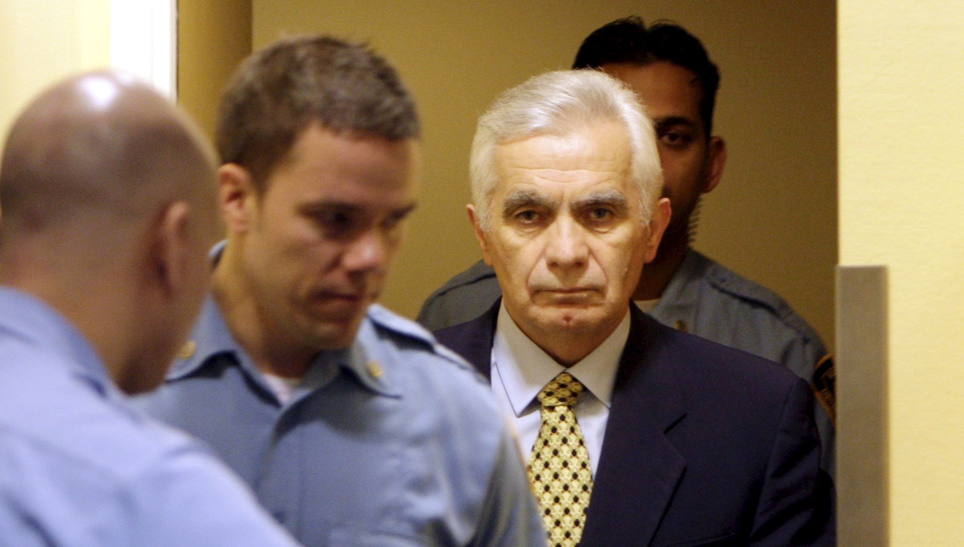 epa08669665 (FILE) - The former speaker of the Bosnian Serb parliament Momcilo Krajisnik (R) enters the courtroom for his appeals verdict at the courtroom of the U.N. Yugoslav war crimes tribunal in the Hague, Netherlands, 17 March 2009 (reissued 15 September 2020). University Clinical Centre in Banja Luka, Bosnia Herzegovina said 15 September 2020 Momcilo Krajisnik, a Bosnian Serb political leader, has died of infection with the novel coronavirus at the clinic in Banja Luka, Bosnia Herzegovina. Krajisnik was found guilty in 2006 of committing crimes against humanity during the Bosnian War by the International Criminal Tribunal for the former Yugoslavia (ICTY) and was sentenced to 20 years' imprisonment. He was 01 September 2013  granted early release after serving two thirds of the sentence.  EPA/BAS CZERWINSKI / POOL