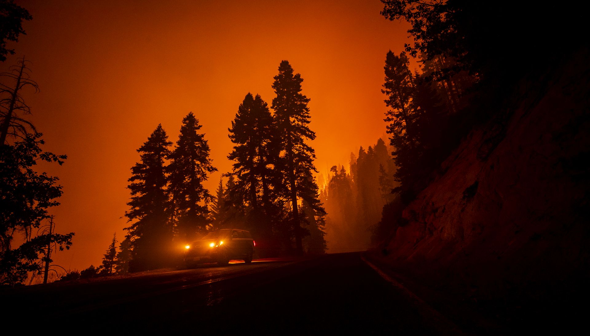 epa08669805 A firefighter checks the evolution of the fire from his car as the Castle Fire burns in the Sequoia National Forest prompting evacuations, between Ponderosa and Camp Nelson, California, USA, 15 September 2020. According to reports, the Castle Fire has burnt over 90,000 acres of forest.  EPA/ETIENNE LAURENT