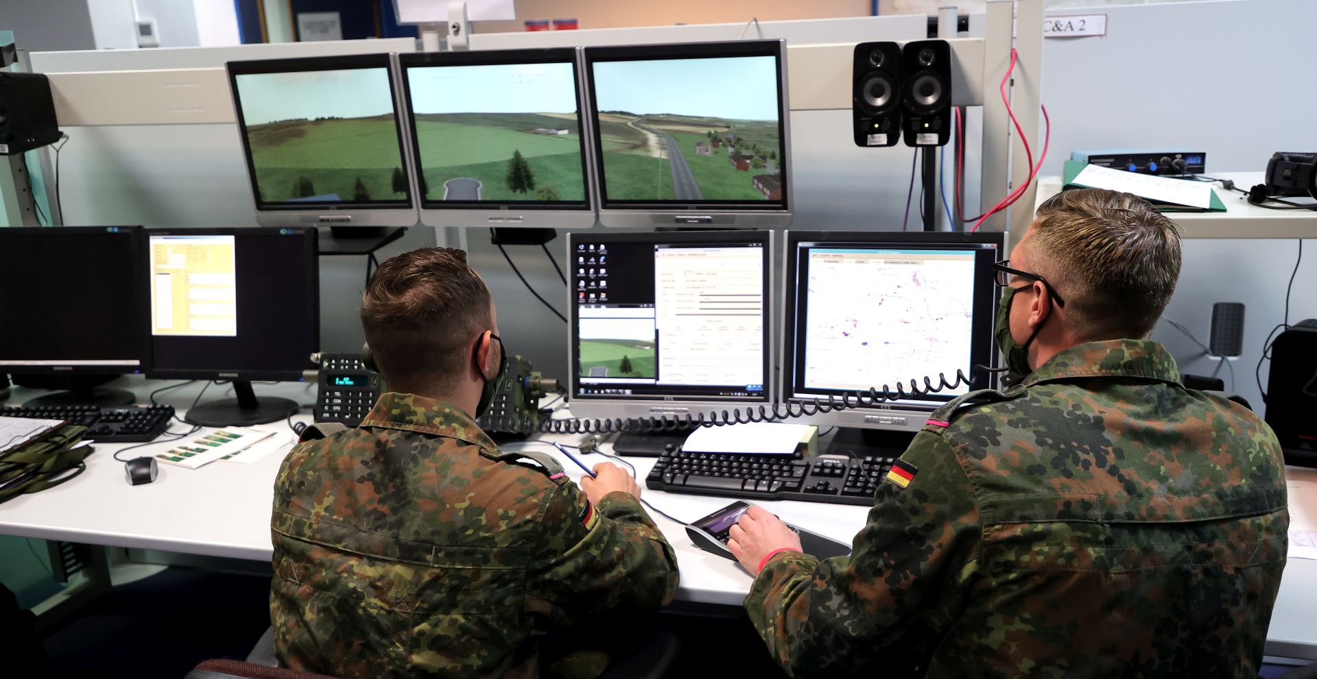 epa08672627 German soldiers monitor the exercise in the control room during the media presentation of the British-German Military Cooperation at the British Simulation Centre in Paderborn, Germany, 16 September 2020. The German Army Tank Battalion 203 from Augustdorf has been training in the simulation centre of the British Army since the beginning of September. The training weeks focus on the use of a tank platoon for combat reconnaissance.  EPA/FRIEDEMANN VOGEL