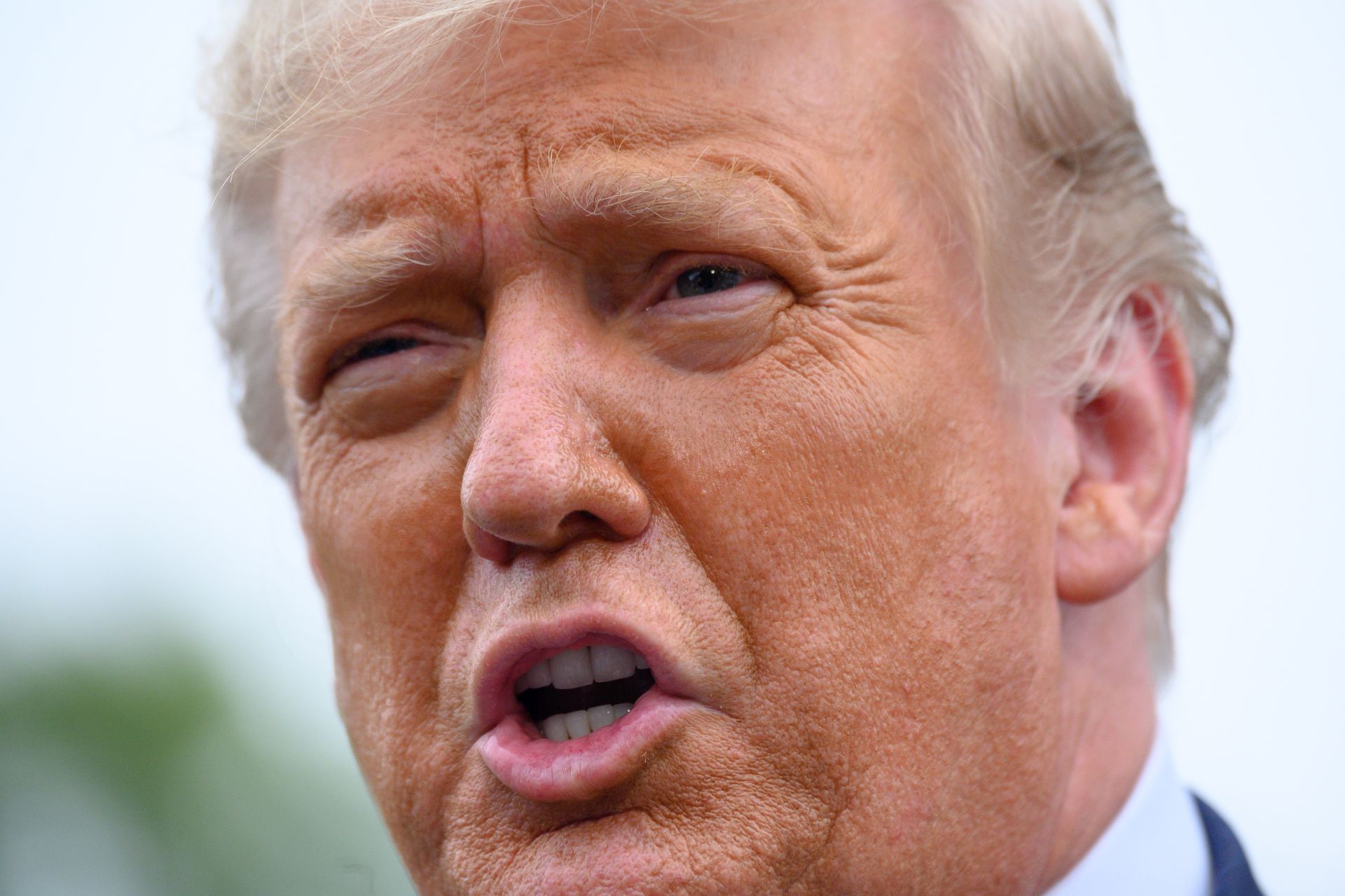 epa08695060 US President Donald J. Trump speaks to members of the media on the South Lawn of the White House before boarding Marine One in Washington, DC, USA, on 24 September 2020 as he departs for campaign events in North Carolina and Florida.  EPA/ERIN SCOTT / POOL