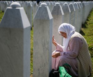 Bosnia and Herzegovina commemorates 25th anniversary of Srebrenica massacre, in Potocari A woman prays at a graveyard, ahead of a mass funeral in Potocari near Srebrenica, Bosnia and Herzegovina July 11, 2020. Bosnia marks the 25th anniversary of the massacre of more than 8,000 Bosnian Muslim men and boys, with many relatives unable to attend due to the coronavirus disease (COVID-19) outbreak. REUTERS/Dado Ruvic DADO RUVIC
