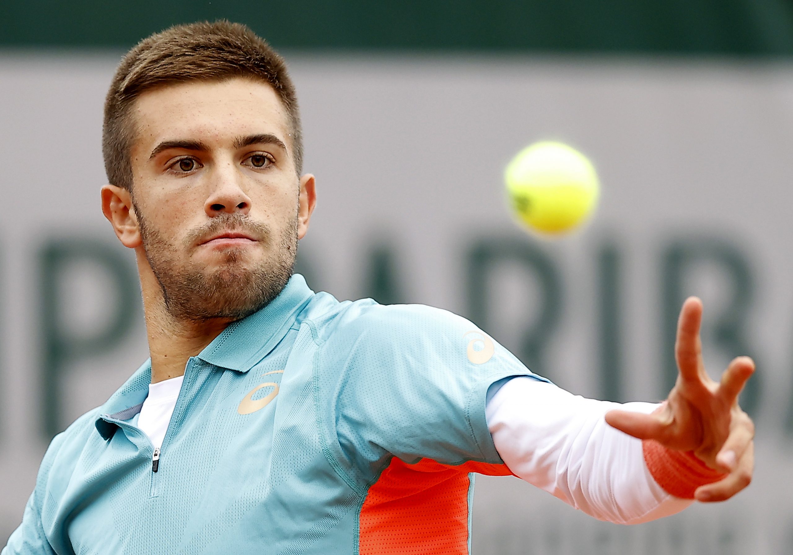 epa08701434 Borna Coric of Croatia in action against Norbert Gombos of Slovakia during their men’s first round match during the French Open tennis tournament at Roland Garros in Paris, France, 27 September 2020.  EPA/IAN LANGSDON