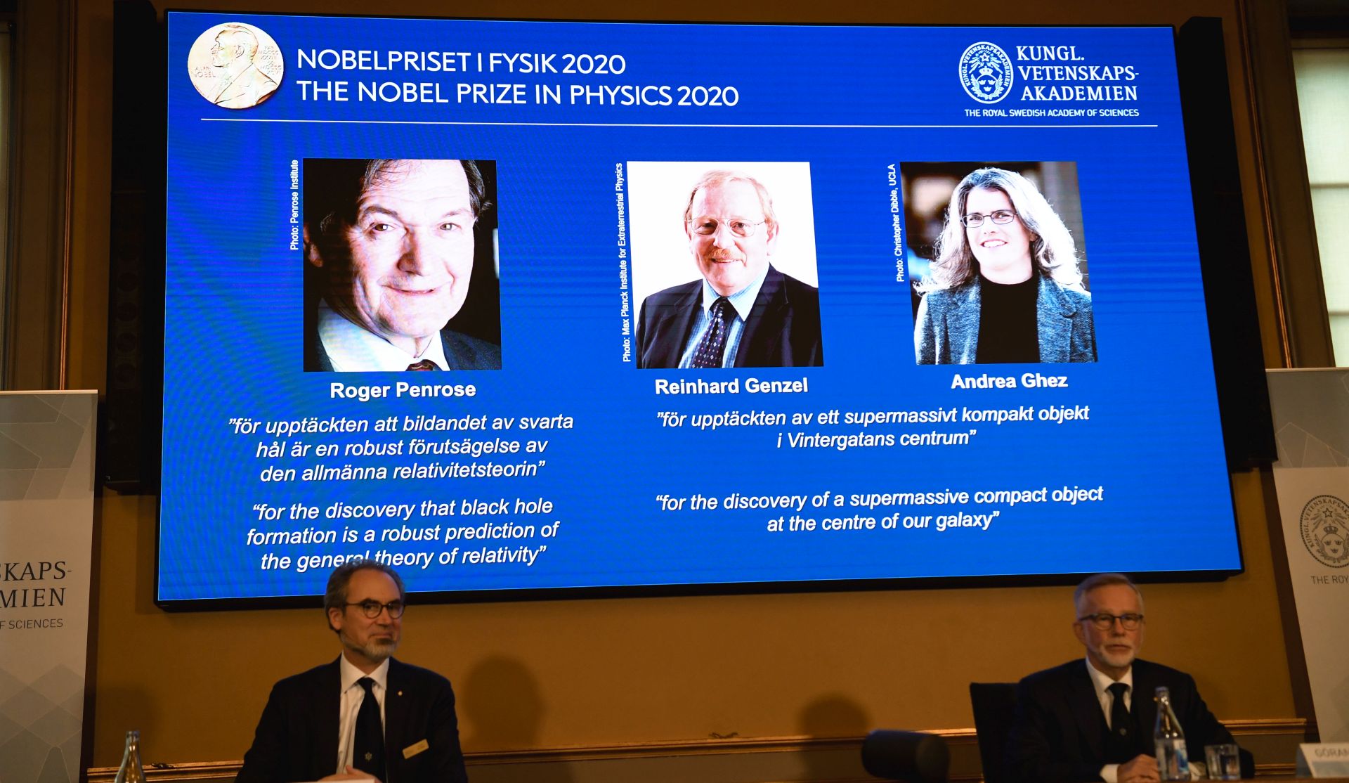 epa08723686 David Haviland (L), member of the Nobel Committee for Physics, and Goran K. Hansson (R), Secretary General of the Academy of Sciences, announce the winners of the 2020 Nobel Prize in Physics during a news conference at the Royal Swedish Academy of Sciences, in Stockholm, Sweden, 06 October 2020. The joint winners of the 2020 Nobel Prize in Physics are (L-R, on screen) Roger Penrose, Reinhard Genzel and Andrea Ghez.  EPA/Fredrik Sandberg / POOL SWEDEN OUT