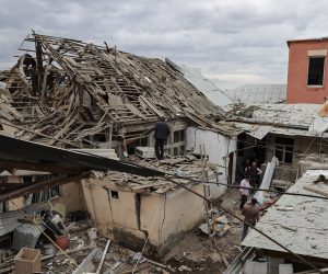 epa08724889 People examine their house allegedly damaged by an alleged recent shelling in the downtown of Ganja in Agdam region in Nagorno Karabakh, 06 October 2020. Armed clashes erupted on 27 September 2020 in the simmering territorial conflict between Azerbaijan and Armenia over the Nagorno-Karabakh territory along the contact line of the self-proclaimed Nagorno-Karabakh Republic (also known as Artsakh).  EPA/AZIZ KARIMOV