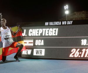 epa08727896 Uganda's Joshua Cheptegei poses for photographs after setting a new men's 10,000m world record at the NN Valencia World Record Day athletics meeting held at Turia stadium in Valencia, eastern Spain, 07 October 2020.  EPA/Manuel Bruque