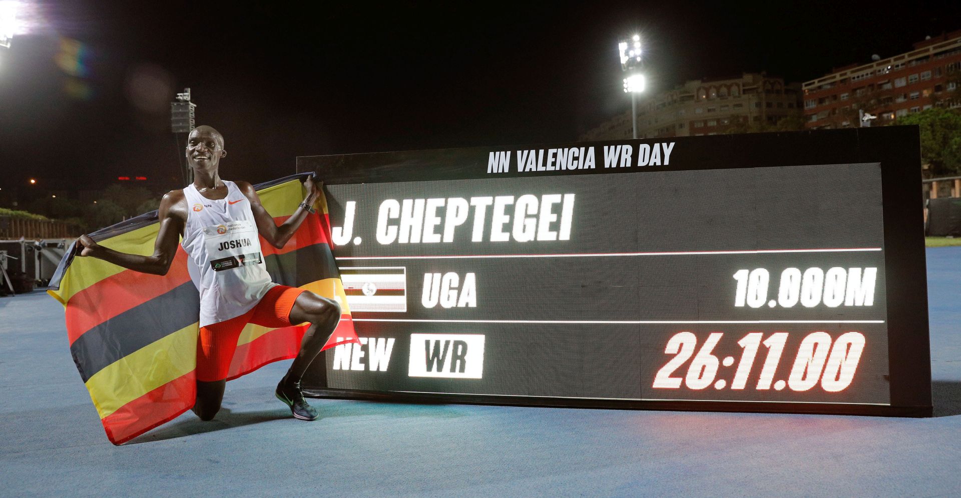 epa08727896 Uganda's Joshua Cheptegei poses for photographs after setting a new men's 10,000m world record at the NN Valencia World Record Day athletics meeting held at Turia stadium in Valencia, eastern Spain, 07 October 2020.  EPA/Manuel Bruque