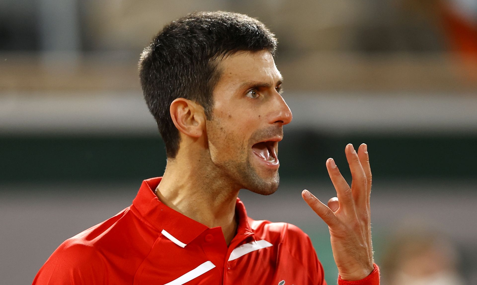 epa08732868 Novak Djokovic of Serbia reacts as he plays Stefanos Tsitsipas of Greece during their men’s semi final match during the French Open tennis tournament at Roland ​Garros in Paris, France, 09 October 2020.  EPA/IAN LANGSDON