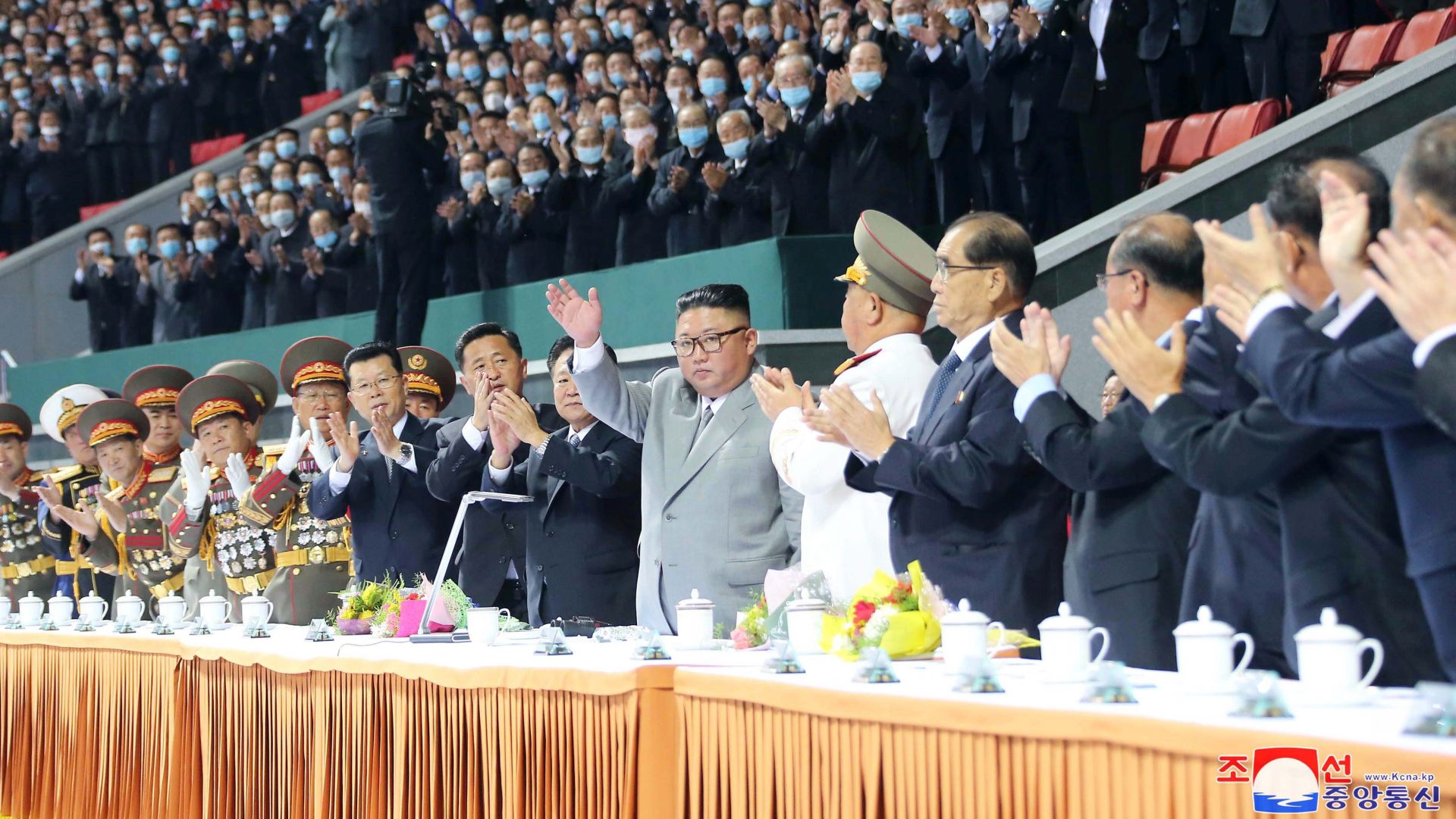 epa08737329 A photo released by the official North Korean Central News Agency (KCNA) shows North Korean leader Kim Jong-un (C) waves during a mass gymnastics and artistic performance at the May Day Stadium during celebrations of the 75th anniversary of the founding of the Workers' Party of Korea (WPK), in Pyongyang, North Korea, 11 October 2020 (issued 12 October 2020).  EPA/KCNA   EDITORIAL USE ONLY
