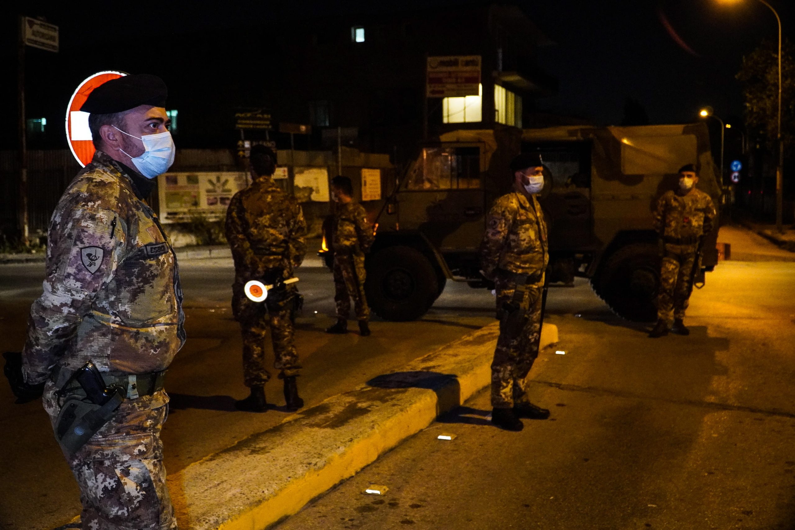 epa08763037 Italian soldiers stand guard at one of the entrances to Arzano, after the town in the hinterland of Naples was declared a red zone due to COVID-19, Naples, Italy, 21 October 2020.  EPA/CESARE ABBATE