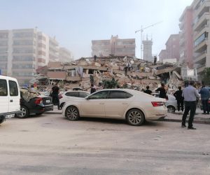 epa08785718 People near a collapsed building after a 7.0 magnitude earthquake in the Aegean Sea in Izmir, Turkey, 30 October 2020. According to Turkish media reports dozens of buildings were destroyed in the earthquake.  EPA/DEMIROREN NEWS AGENCY TURKEY OUT
