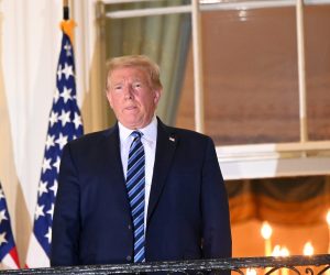 FILE PHOTO: U.S. President Donald Trump returns to the White House after being hospitalized at Walter Reed Medical Center for coronavirus disease (COVID-19), in Washington FILE PHOTO: U.S. President Donald Trump poses atop the Truman Balcony of the White House after taking off his protective face mask as he returns to the White House after being hospitalized at Walter Reed Medical Center for coronavirus disease (COVID-19) treatment, in Washington, U.S. October 5, 2020. REUTERS/Erin Scott/File Photo ERIN SCOTT