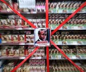 epaselect epa08786094 Picture of French President Macron is posted next to a message 'Boycott French products' at supermarket to protest against French President Macron's comments over Prophet Muhammad caricatures, in Peshawar, Pakistan, 30 October 2020. Calls for boycotting French products spread in several countries in response to French President Emmanuel Macron's comments that his country would not give up publishing Prophet Muhammad’s cartoons following the recent beheading of a teacher in France after he had shown such cartoons in class.  EPA/BILAWAL ARBAB