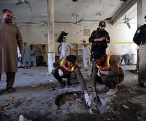 epa08776794 Pakistani security officials inspect the crater formed at the scene of an explosion at an Islamic seminary in Peshawar, Pakistan, 27 October 2020. At least seven people died, including children, and more than 70 were injured in an explosion at a seminary in Peshawar. No group has yet claimed responsibility.  EPA/BILAWAL ARBAB