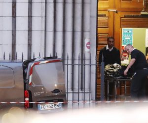 epa08783850 The body of a victim is transported out the Notre Dame Basilica church by officers in Nice, France, 29 October 2020, following a knife attack. Three people have died in what officials treat as a terror attack. The attack comes less than a month after the beheading of a French middle school teacher in Paris on 16 October.  EPA/SEBASTIEN NOGIER