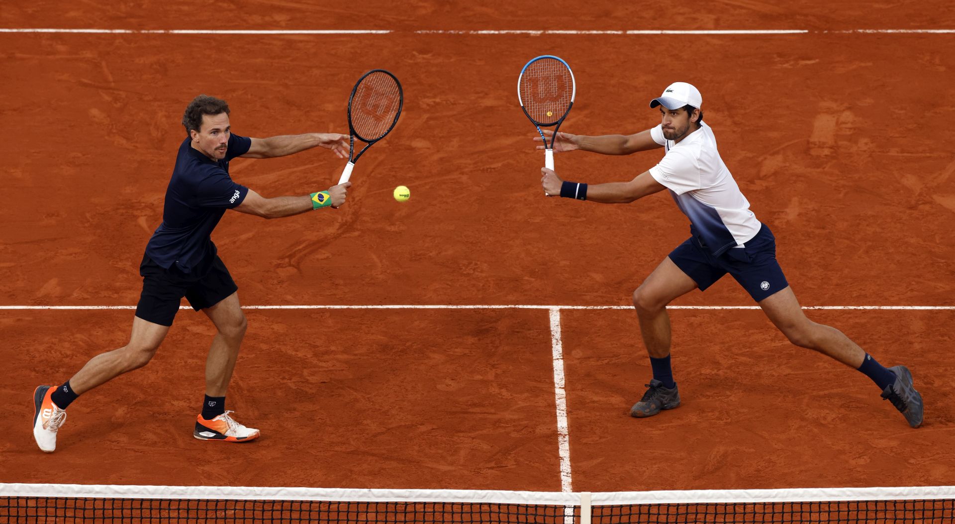 epa08734667 Mate Pavic of Croatia (R) and Bruno Soares of Brazil in action against Kevin Krawietz and Andreas Mies of Germany during the men’s doubles final match during the French Open tennis tournament at Roland Garros in Paris, France, 10 October 2020.  EPA/YOAN VALAT