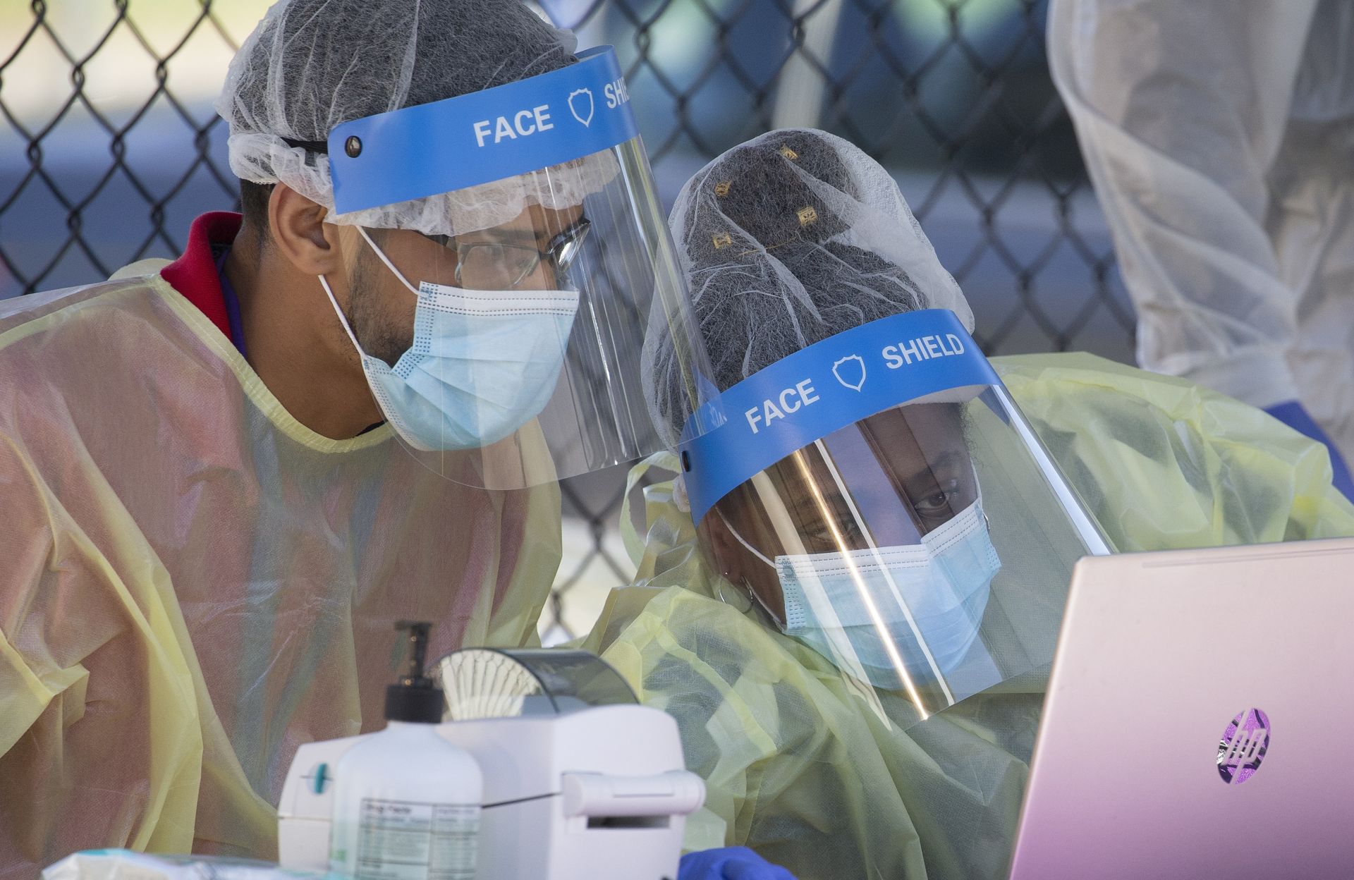 epa08748971 Staff members of the Whittier Street Health Center wear face shields while checking in patients at a pop up coronavirus testing center in Boston, Massachusetts, USA, 15 October 2020. The recent rise in cases has prompted Boston's Mayor Marty Walsh to provide more testing sites for residents.  EPA/CJ GUNTHER