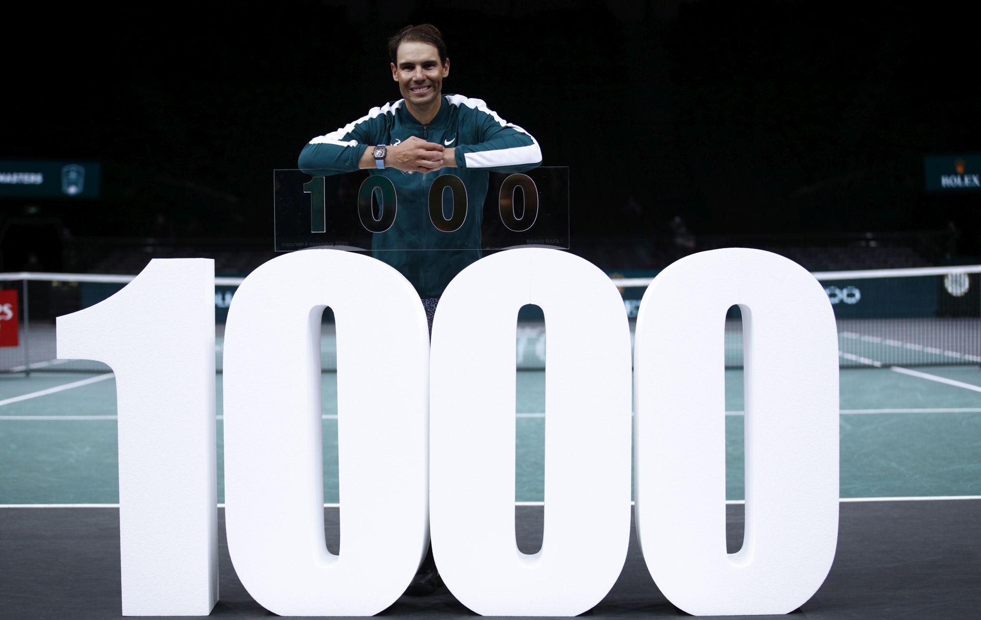 epa08799157 Rafael Nadal of Spain celebrates his victory with a trophy marking his 1,000th win on the main ATP tour following his second round match against Feliciano Lopez of Spain at the Rolex Paris Masters tennis tournament in Paris, France, 04 November 2020.  EPA/YOAN VALAT