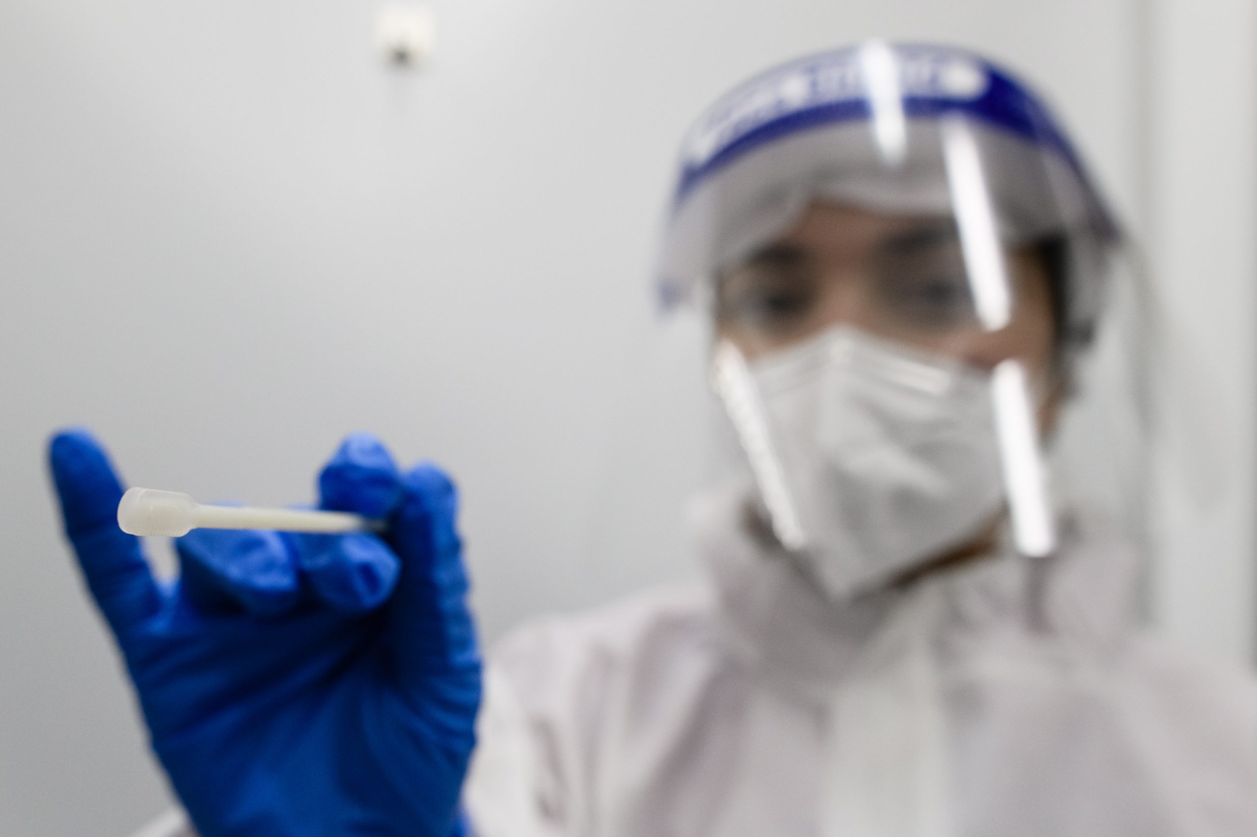 epa08800271 A health worker poses with a swab at a Covid-19 test center at Berlin Brandenburg Airport BER airport in Berlin, Germany, 05 November 2020. The company Centogene runs a walk-in COVID-19 test center at Berlin Brandenburg Airport and other airports in Germany.  EPA/CLEMENS BILAN