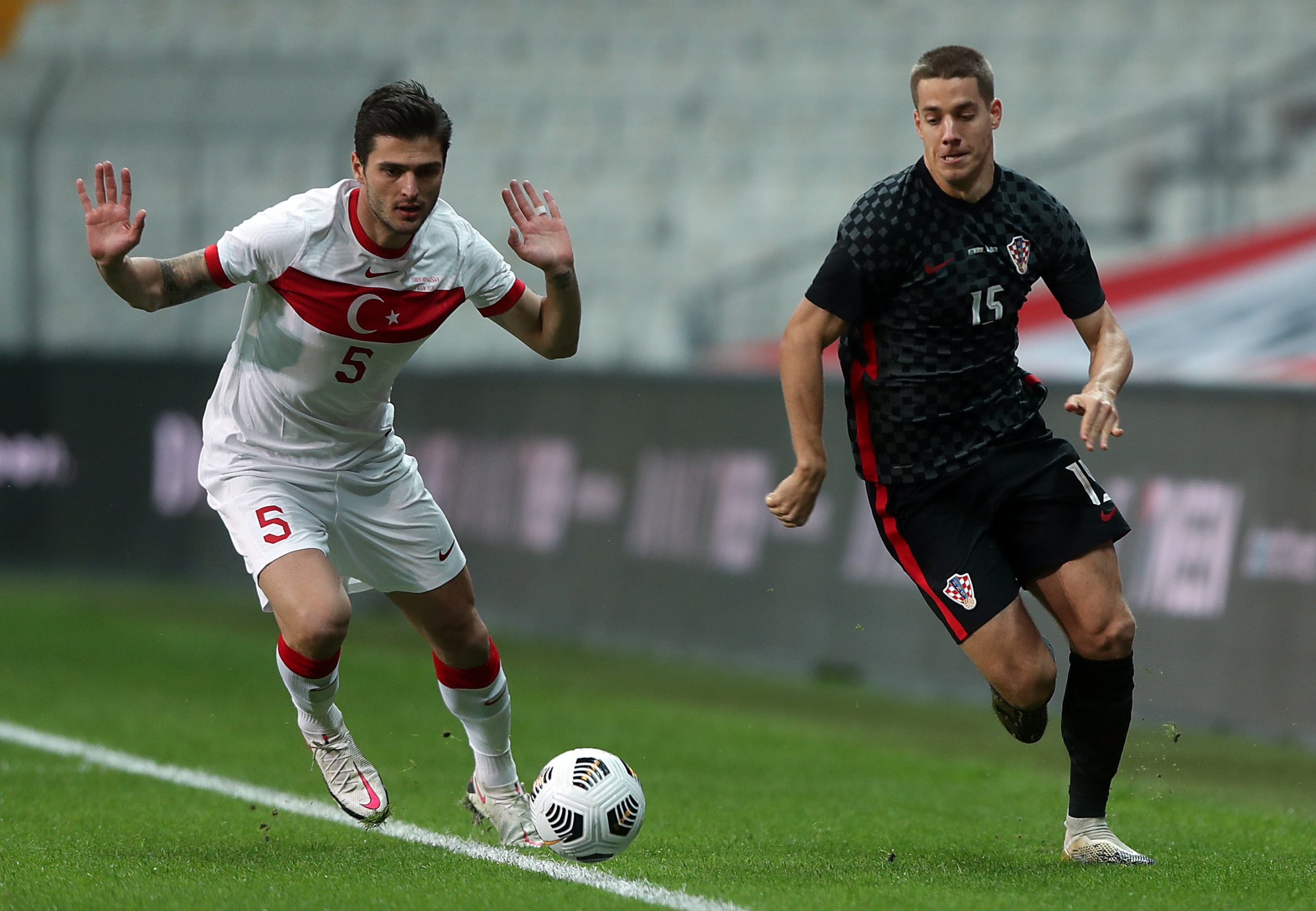 epa08814218 Okay Yokuslu (L) of Turkey in action against Mario Pasalic (R) of Croatia during the international friendly soccer match between Turkey and Croatia in Istanbul, Turkey, 11 November 2020.  EPA/ERDEM SAHIN