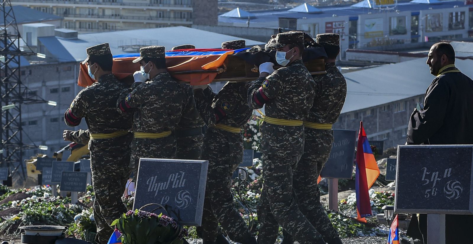epa08817391 Armenian soldiers carry coffins with bodies of killed soldiers during war in the Nagorno-Karabakh Republic in Yerablur Military Memorial Cemetery in Yerevan, Armenia, 12 November 2020 (Issued 13 November 2020). On 09 November Azerbaijan President Aliyev, Armenian Prime Minister Pashinyan and Russian President Putin signed a statement announcing a complete ceasefire and all military operations in the Nagorno-Karabakh conflict zone from 00:00 a.m. Moscow time on 10 November 2020. Armed clashes erupted on 27 September 2020 in the simmering territorial conflict between Azerbaijan and Armenia over the Nagorno-Karabakh territory along the contact line of the self-proclaimed Nagorno-Karabakh Republic (also known as Artsakh).  EPA/LUSI SARGSYAN / PHOTOLURE PICTURE MADE AVAILABLE TODAY