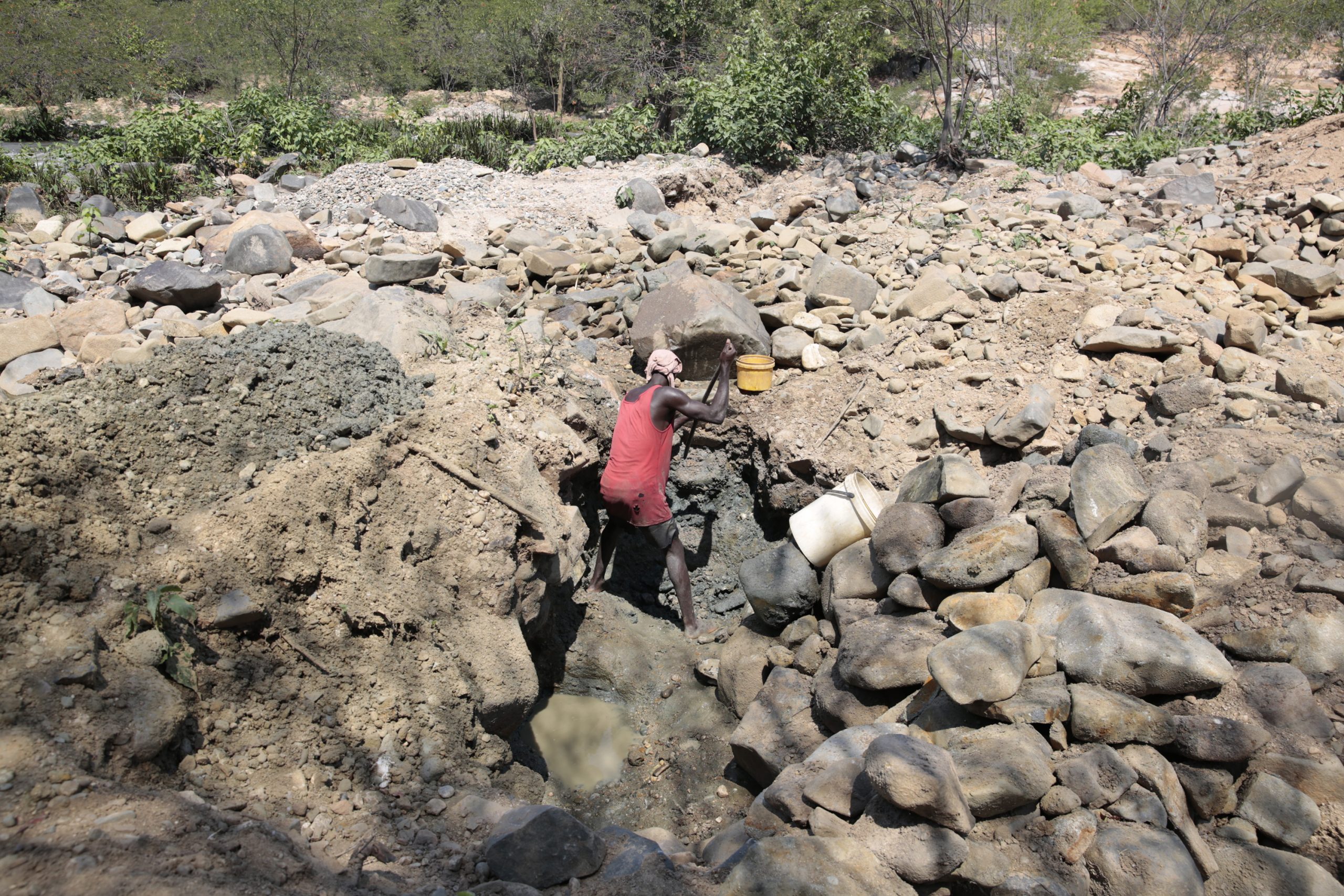 epa08807726 Land degradation caused by gold panners in search of gold rich soil for the process of gold panning along Odzi River outside Mutare, Zimbabwe, 07 November 2020  (Issued 08 November 2020). Many children who are out of school, due to poverty and a crippling strike by teachers are complimenting household incomes by doing odd jobs such as gold panning along rivers and deep pits.  EPA/AARON UFUMELI