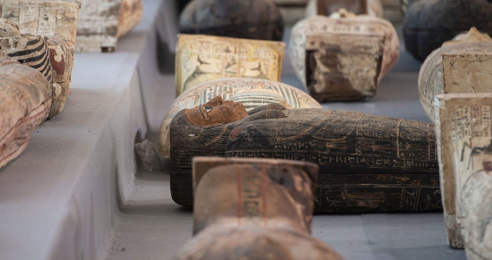 epa08819627 Sarcophaguses are presented to the media near the newly discovered burial site at Saqqara Necropolis in Giza, Egypt, 14 November 2020. The large number of colored human coffins are more than 2,500 years old, aoccording to Egypt's Ministry of Tourism and Antiquities.  EPA/Mohamed Hossam