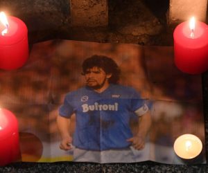epa08842274 A picture of Maradona as Napoli soccer supporters stand outside the San Paolo stadium to pay tribute to Maradona in Naples, Italy, 25 November 2020. Diego Maradona has died after a heart attack, media reports claimed on 25 November 2020.  EPA/CIRO FUSCO