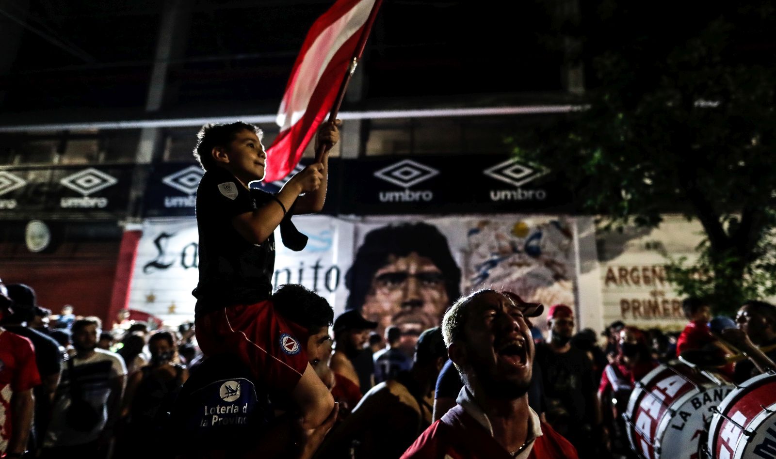 epa08842751 Fans gather to honor Diego Armando Maradona at the Club Argentinos Juniors Stadium, in Buenos Aires, Argentina, 25 November 2020. Diego Maradona has died at the age of 60 after a heart attack on 25 November 2020.  EPA/Juan Ignacio Roncoroni