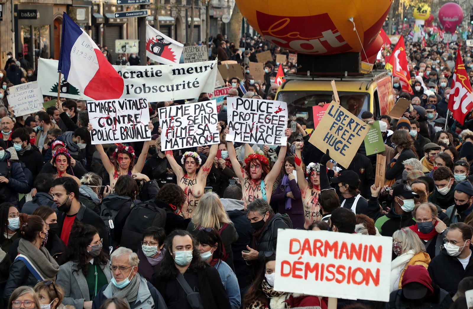 epa08848605 Femen activists hold up placard as they join protesters near Place de la Republique to demonstrate against the controversial global security law undergoing parliamentary approval, in Paris, France, 28 November 2020. The global security legislation in the process of being passed by the French Parliament aims to ban the sharing of photos in which police officers and gendarmes can be identified in a way which is harmful to their image. France has seen several protests opposing the proposed law in the past week - but a recent incident in which French police were caught on security camera footage beating a black man in his record studio in Paris has further fueled the backlash against the new legislation.  EPA/CHRISTOPHE PETIT TESSON