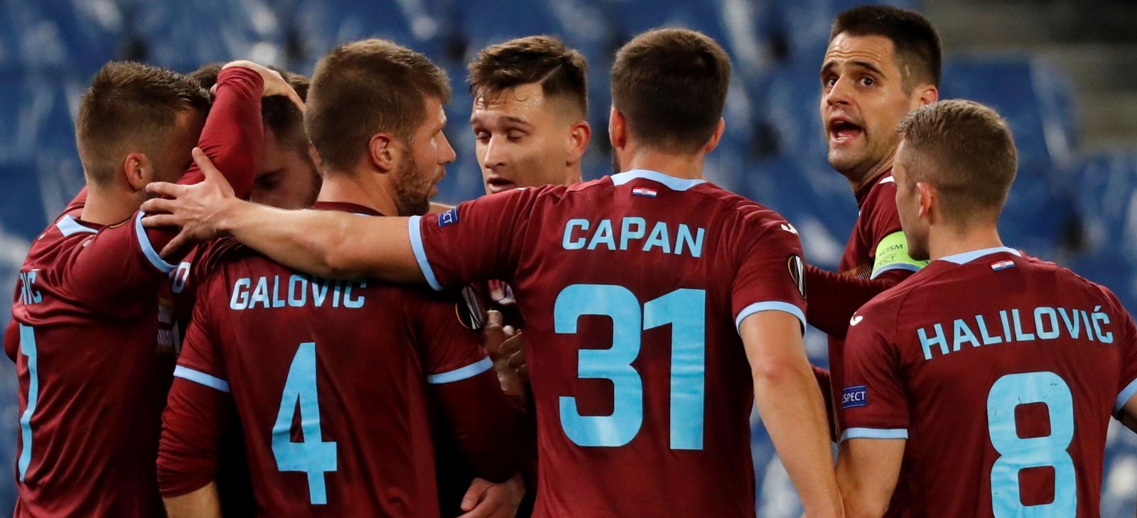 epa08860642 HNK Rijeka's Darko Velkovski (2-L) celebrates with teammates after scoring the 0-1 lead during the UEFA Europa League Group F  match between Real Sociedad and HNK Rijeka at Reale Arena stadium in San Sebastian, Basque Country, Spain, 03 December 2020.  EPA/Juan Herrero
