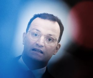epa08862094 German Health Minister Jens Spahn is seen behind reflecting lights of a TV camera during a press statement in Berlin, Germany, 04 December 2020. German Health Minister Jens Spahn and Federal Government Commissioner for Nursing Andreas Westerfellhaus presented on 04 December 2020 a guideline as an assistance in the development of visit concepts for nursing homes.  EPA/CLEMENS BILAN