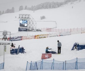 epa08863368 Volunteers work in the finish area, in St. Moritz, Switzerland, 05 December 2020. Due to a heavy snowfall and strong wind, the FIS decided to cancel the women's Super-G race of the FIS Alpine Ski World Cup.  EPA/JEAN-CHRISTOPHE BOTT