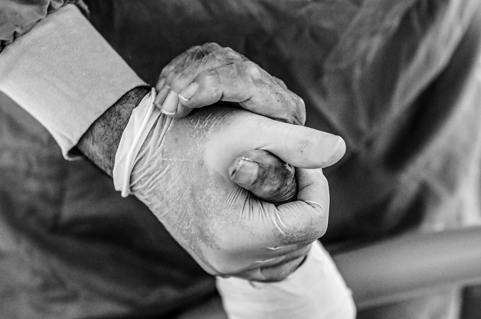 epa08872039 A doctor holds a hand of COVID-19 patient inside a sealed Intensive Care Unit (ICU) room at the Prof. Dr. Cemil Tascioglu City Hospital, in Istanbul, Turkey, 07 December 2020 (issued 09 December 2020). According to latest reports, Turkey recorded 33,198 new coronavirus infections on 08 December 2020, the highest daily number in Europe. Since the start of the Covid-19 pandemic more than 15,000 people have died in Turkey, including 211 health workers, who take care of coronavirus patients, according to Turkey Medical Association. Turkish government in November 2020 has signed a contract to buy 50 million doses of Chinese manufacturer Sinovac coronavirus vaccine ‘CoronaVac’, to be delivered in batches between December 2020 and February 2021. Turkey is also in talks to increase the amount of coronavirus vaccines from Pfizer and BioNTech companies, from initial one million doses. Healthcare workers, people aged 65 and above, disabled people, people who stay in shelters and those living in crowded places will be vaccinated in the first stage, Turkish Health Ministry said.  EPA/SEDAT SUNA ATTENTION: This Image is part of a PHOTO SET