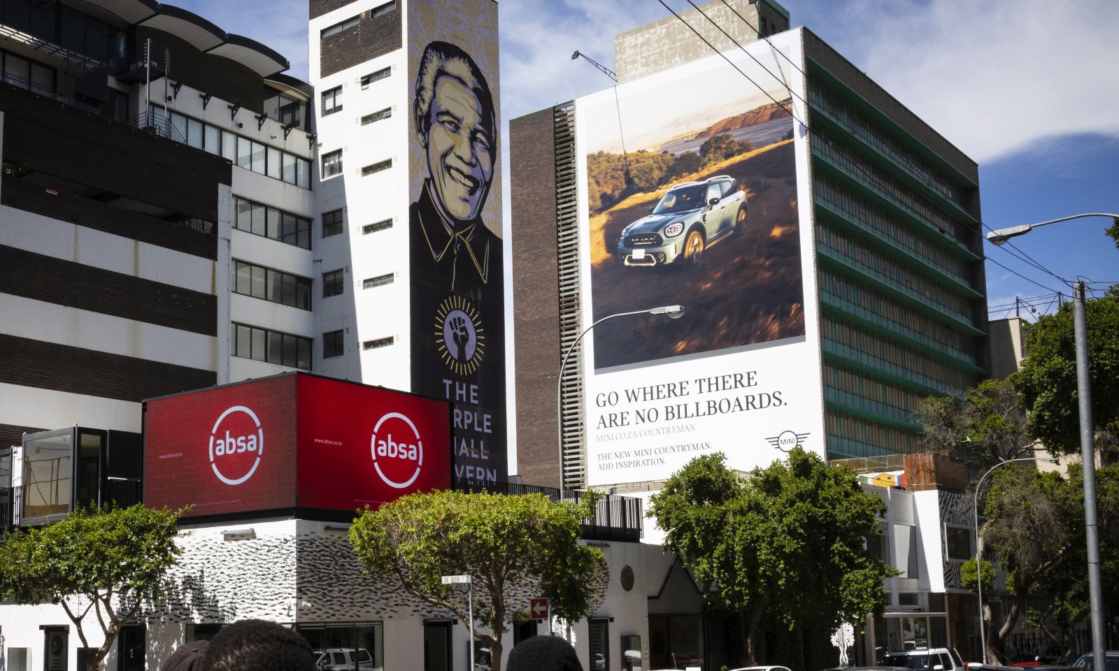 epa08873871 Pedestrians walk past bank and car dealership advertising in downtown Johannesburg, South Africa, 10 December 2020. Data from STATS SA, the national statistical service of South Africa, revealed that the economy has grown since the relaxing of Covid-19 Corona virus lockdown, with a GDP growth recording 13.5 percent in the third quarter of the year. This was recorded despite the harsh level 5 national lockdown that virtually closed the country's economy for months.  EPA/KIM LUDBROOK