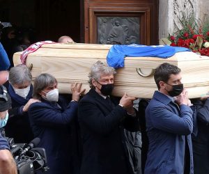 epa08878937 The coffin is carried out of the Santa Maria Annunciata Cathedral after the funeral mass for Paolo Rossi, in Vicenza, northeastern Italy, 12 December 2020. Former Italian soccer player Paolo Rossi, who led the national team to its 1982 World Cup victory, had died on 09 December 2020 in Siena at the age of 64.  EPA/NICOLA FOSSELLA