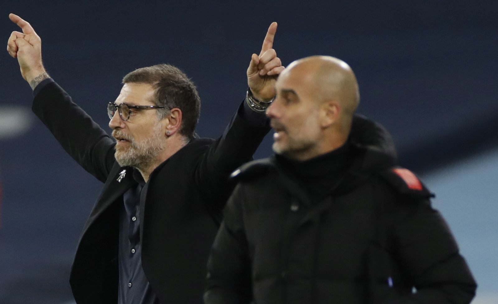 epa08886420 West Bromwich's manager Slaven Bilic (L) gives instructions to his players as Manchester City's manager Pep Guardiola (R) follows the game during the English Premier League match between Manchester City vs West Bromwich Albion FC in Manchester, Britain, 15 December 2020.  EPA/Clive Brunskill / POOL EDITORIAL USE ONLY. No use with unauthorized audio, video, data, fixture lists, club/league logos or 'live' services. Online in-match use limited to 120 images, no video emulation. No use in betting, games or single club/league/player publications.