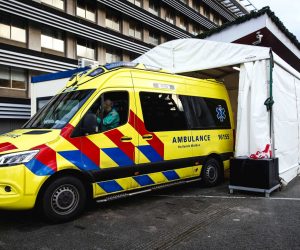 epa08889871 An ambulance at a medical cabin at the emergency department of the Groene Hart Hospital, where corona suspected patients are received in Gouda, the Netherlands, 17 December 2020. The temporary cabin is to separate patients with and without corona as they are admissioned to the hospital.  EPA/SEM VAN DER WAL