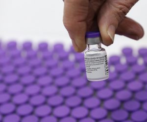 epaselect epa08894698 A medical staff of Shaare Zedek Medical Center holds Pfizer ‏coronavirus COVID-19 pandemic vaccines at the Shaare Zedek Medical Center in Jerusalem Israel, 19 December 2020. Israel begins a nationwide COVID-19 vaccination campaign as hundreds of thousands of vaccines are delivered to hospitals across the country. First, the medical staff will be vaccinated and then people from high potential risk groups and the elderly population. Authorities hope to vaccinate as many people as possible.  EPA/ABIR SULTAN