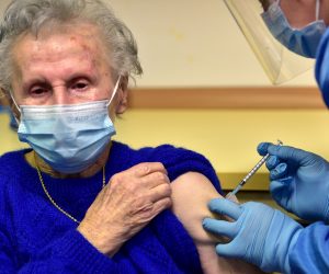epa08905639 A Slovenian patient (L) receives a vaccine of the Pfizer-BioNTech against the COVID-19 at the Home for Elderly people Fuzine, in Ljubljana, Slovenia, 27 December 2020.  EPA/IGOR KUPLJENIK