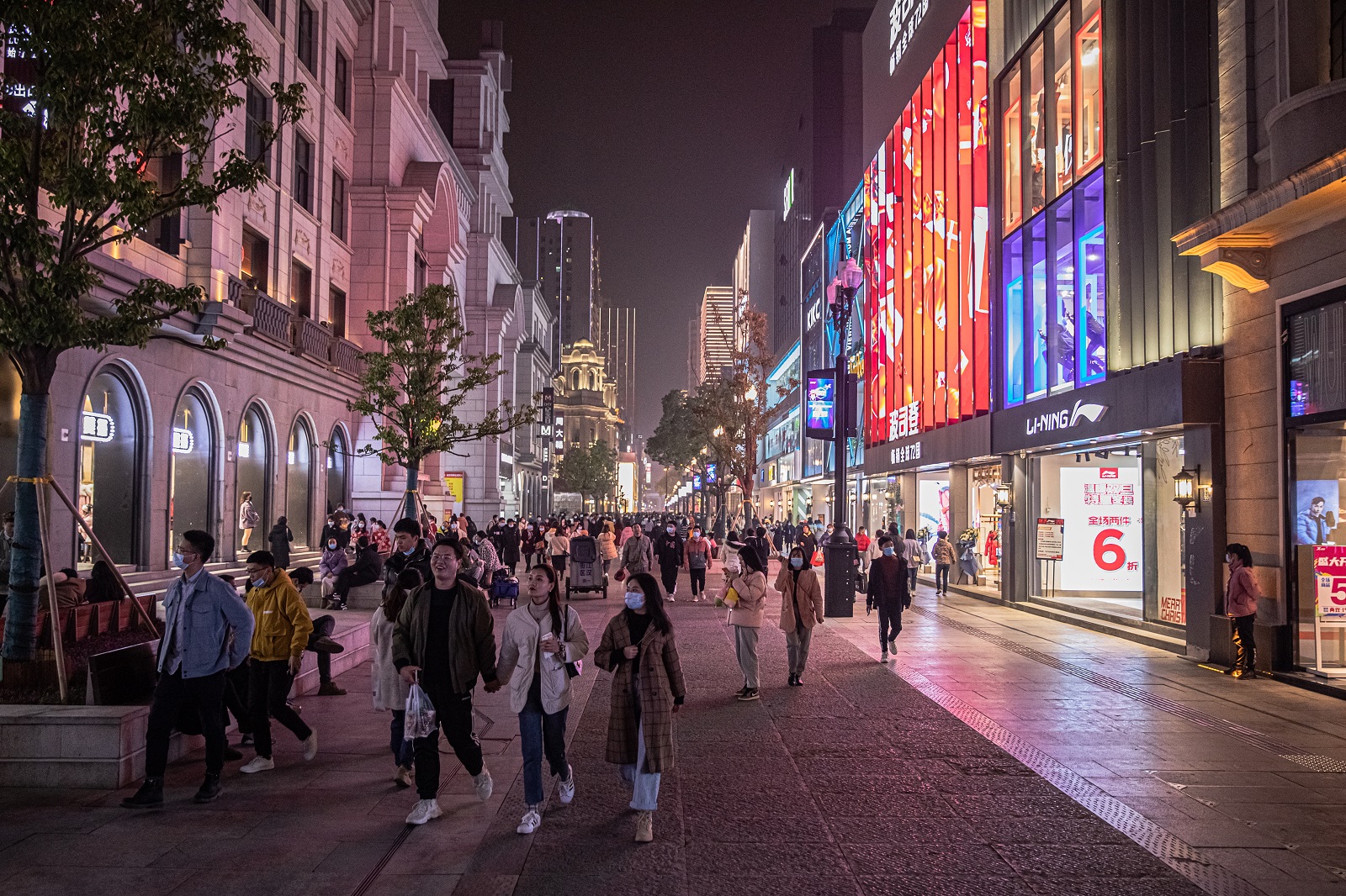 epa08908118 People walk in a shopping street in Wuhan, China, 28 December 2020. Life in Wuhan, a Chinese city of more than 11 million, which nearly a year ago became the epicenter of the coronavirus outbreak is returning to normal. Since May the capital of Hubei province has not recorded locally-transmitted cases of Covid-19.  EPA/ROMAN PILIPEY