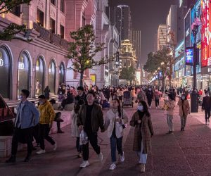 epa08908118 People walk in a shopping street in Wuhan, China, 28 December 2020. Life in Wuhan, a Chinese city of more than 11 million, which nearly a year ago became the epicenter of the coronavirus outbreak is returning to normal. Since May the capital of Hubei province has not recorded locally-transmitted cases of Covid-19.  EPA/ROMAN PILIPEY