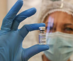 epa08911277 A photograph made available on 30 December shows a medical worker showing a vial with Russian Sputnik V vaccine, during the vaccination against the coronavirus disease (COVID-19) at a state polyclinic in Minsk, Belarus, 29 December 2020. Belarus started mass coronavirus vaccinations with Sputnik V vaccine, local media report.  EPA/ANDREI POKUMEIKO / POOL MANDATORY CREDIT